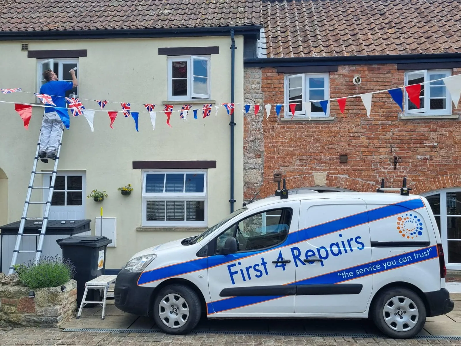 A white van parked in front of a brick building.