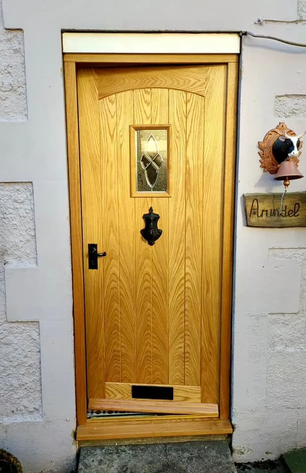 A wooden door on the side of a building.