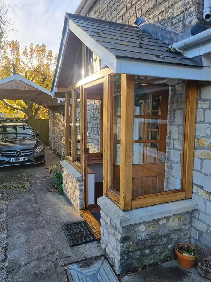 A house with a car parked in front of it.