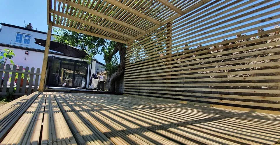 A wooden bench sitting on top of a wooden deck.