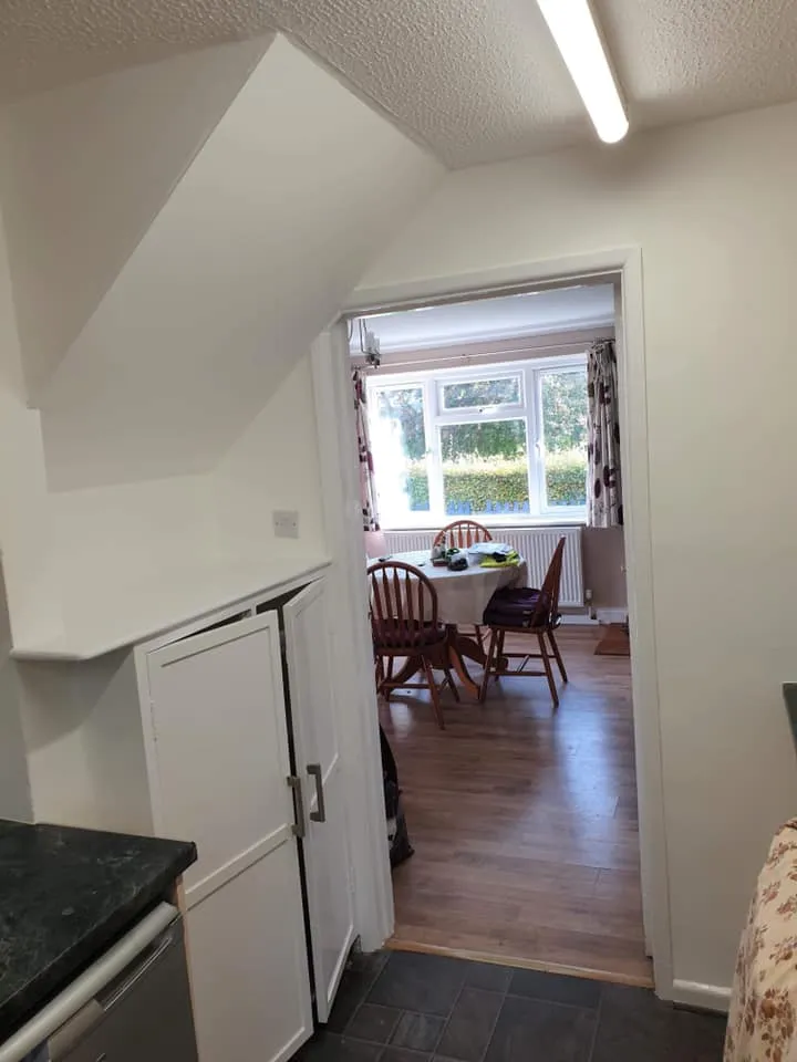 A kitchen with a refrigerator freezer next to a stove top oven.