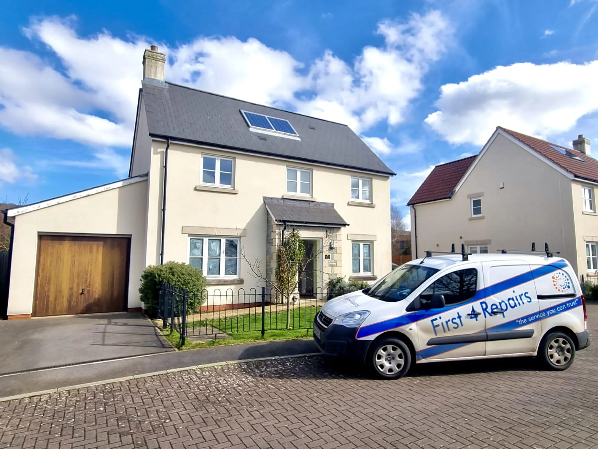 A white van parked in front of a house.